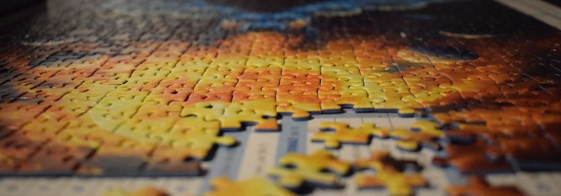 Incomplete jigsaw puzzle with missing pieces in foreground
