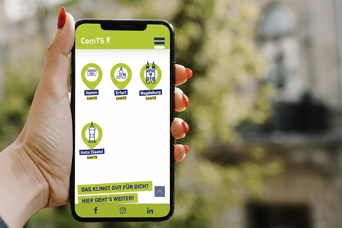 A smartphone displaying the ComTS website with icons for different company locations such as Hamm, Erfurt, Magdeburg, and Halle.